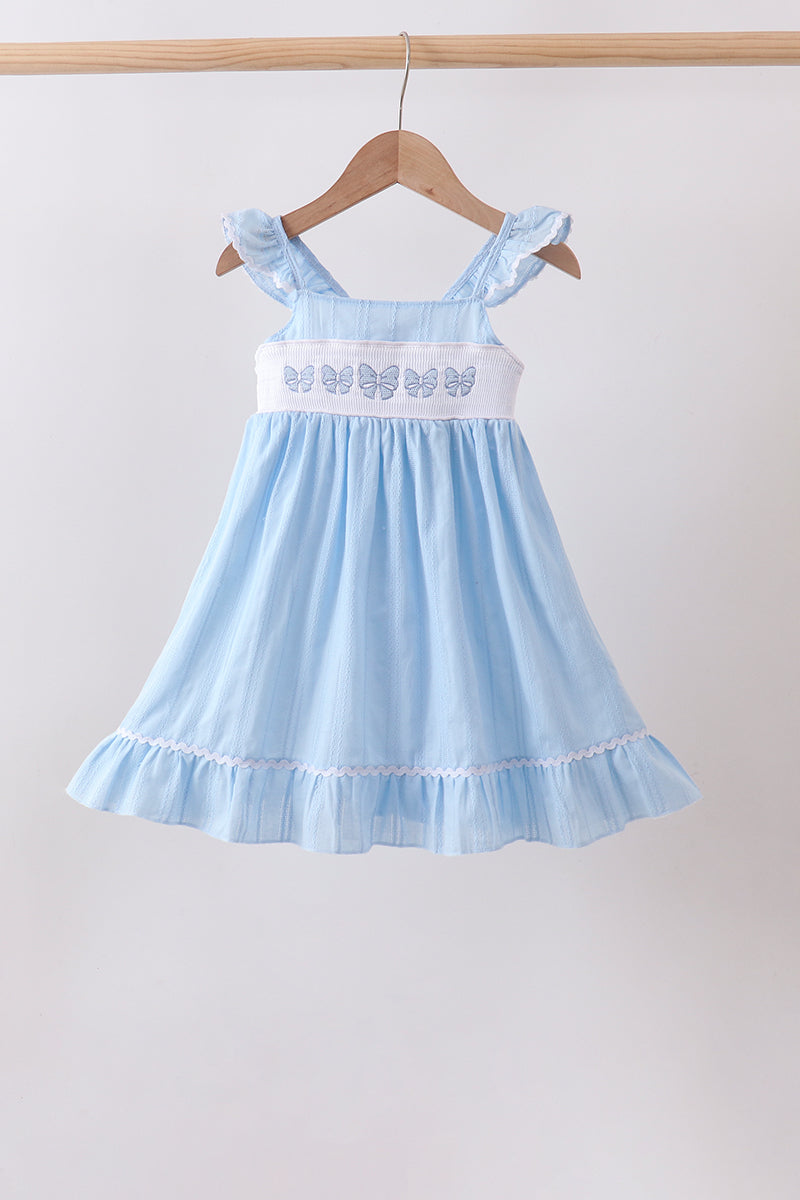 Robe jacquard smockée et brodée à nœud bleu
