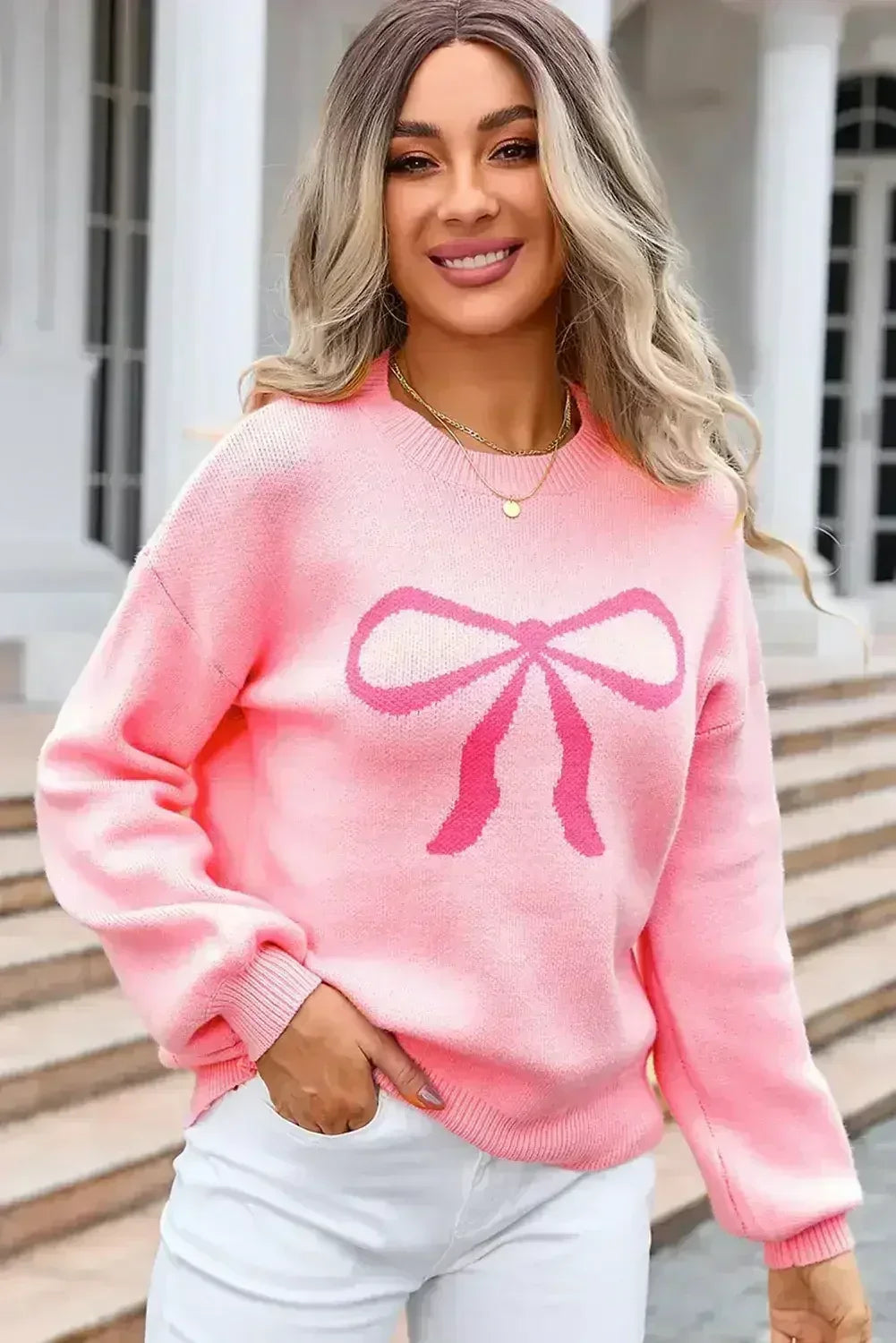 Pull col rond à nœud rose
