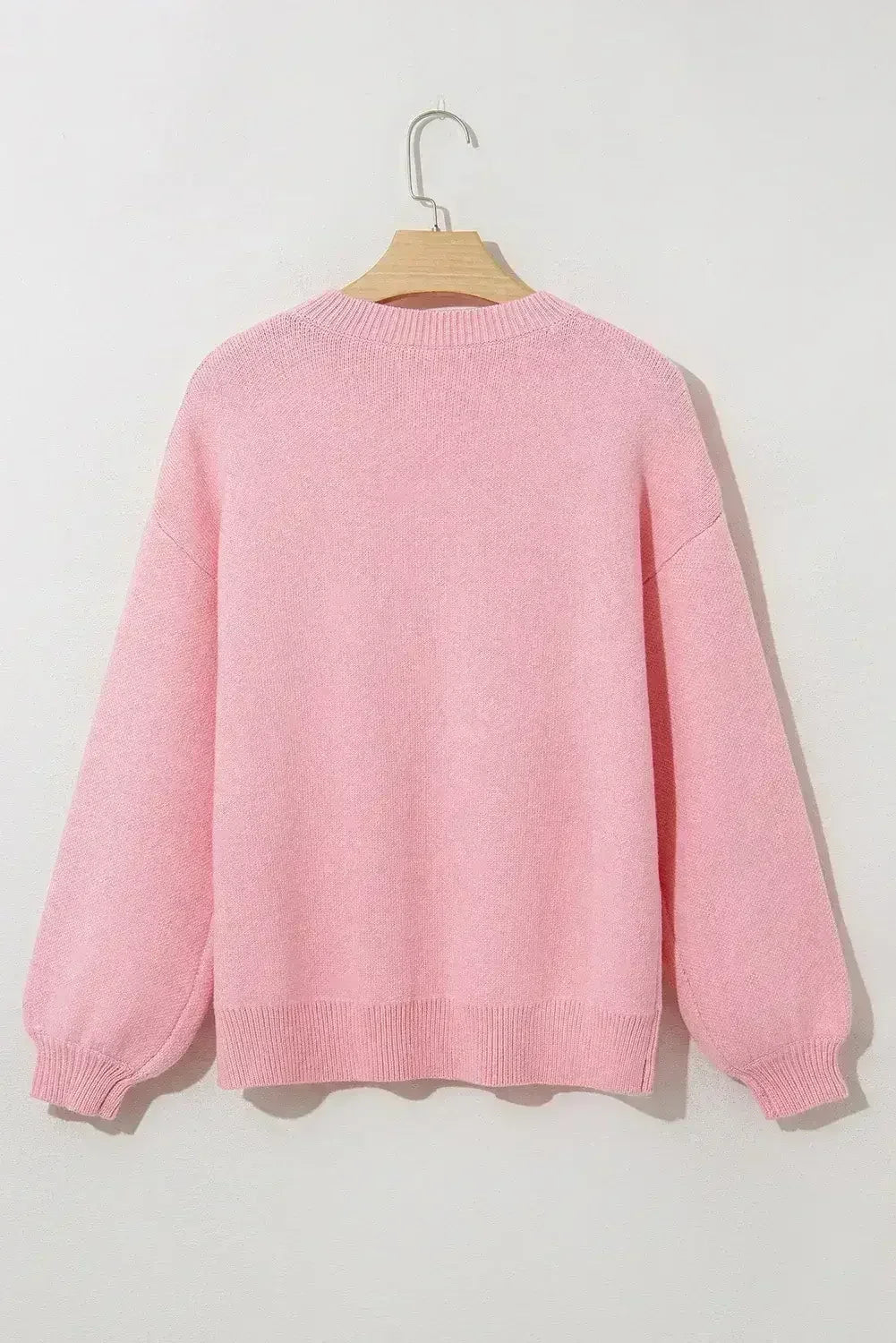 Pull col rond à nœud rose