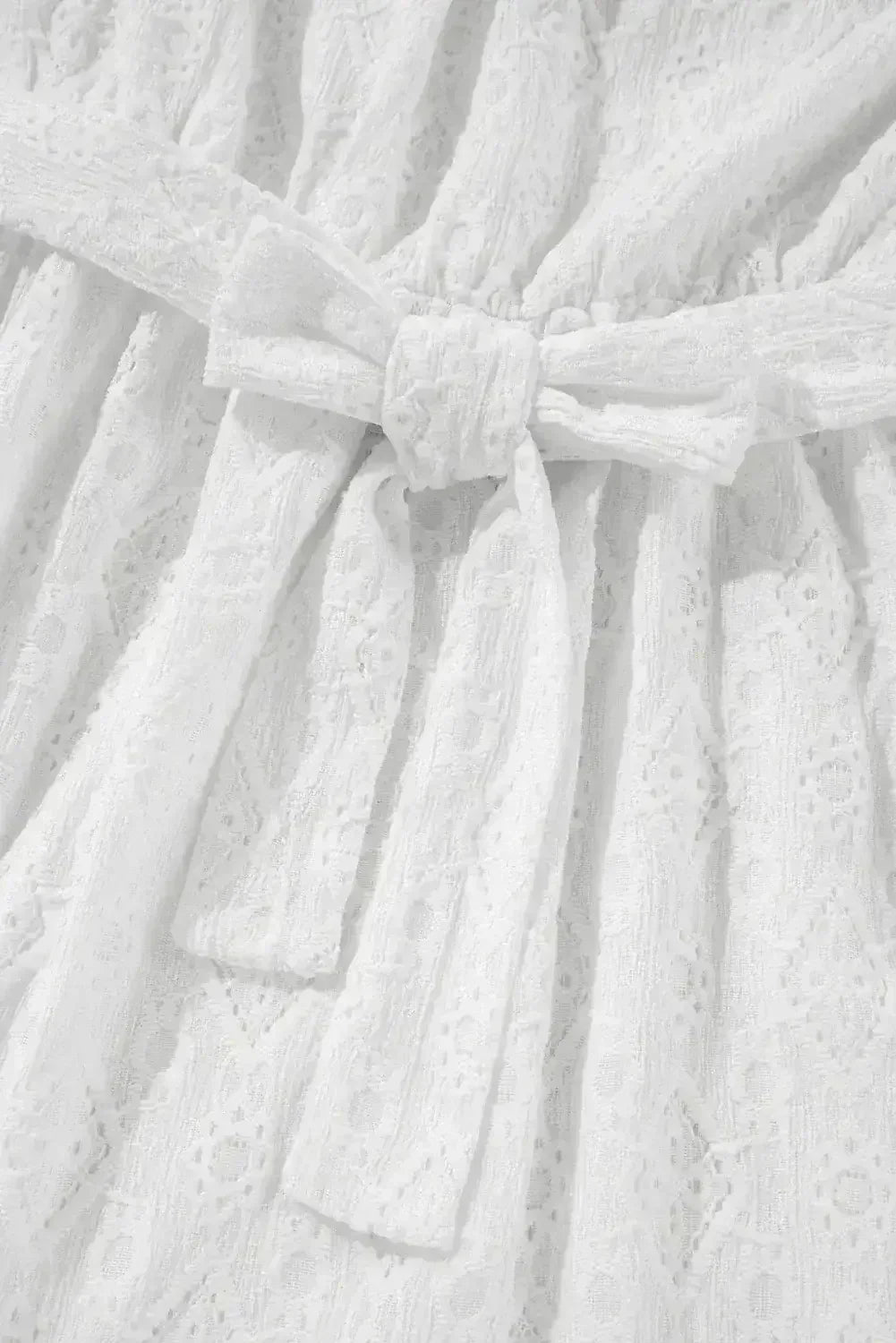 Robe courte blanche sans manches en dentelle avec nœud ajouré au dos et taille nouée