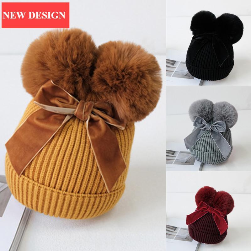 Bonnet tricoté bébé à double pompon pour petite fille, chaud et épais, pour enfant en bas âge, au design hivernal moderne et élégant avec un grand nœud.