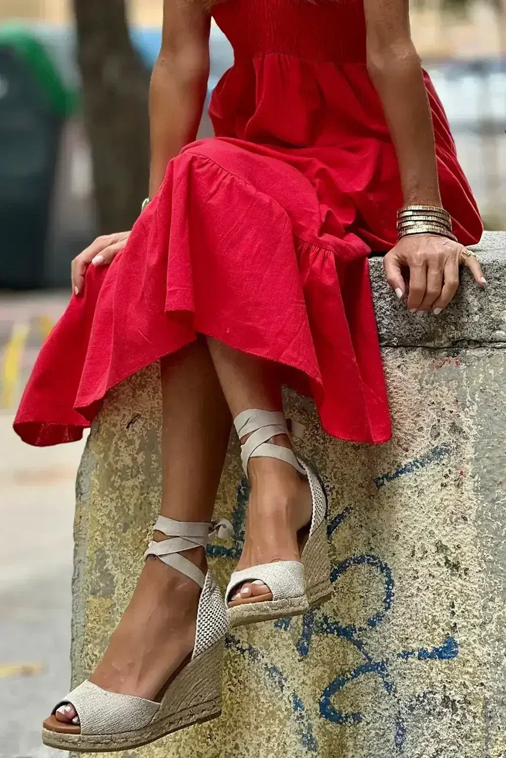Robe longue noire à volants, col en V, taille haute et buste smocké