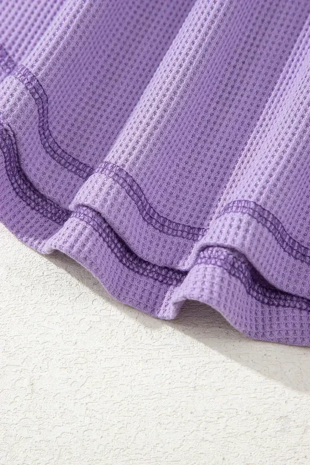 Haut texturé gaufré bleu à col en V avec manches tombantes et coutures apparentes