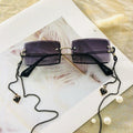 Lunettes de soleil tendance pour femmes sans monture, petits verres rectangulaires, monture en métal de haute qualité et protection UV400