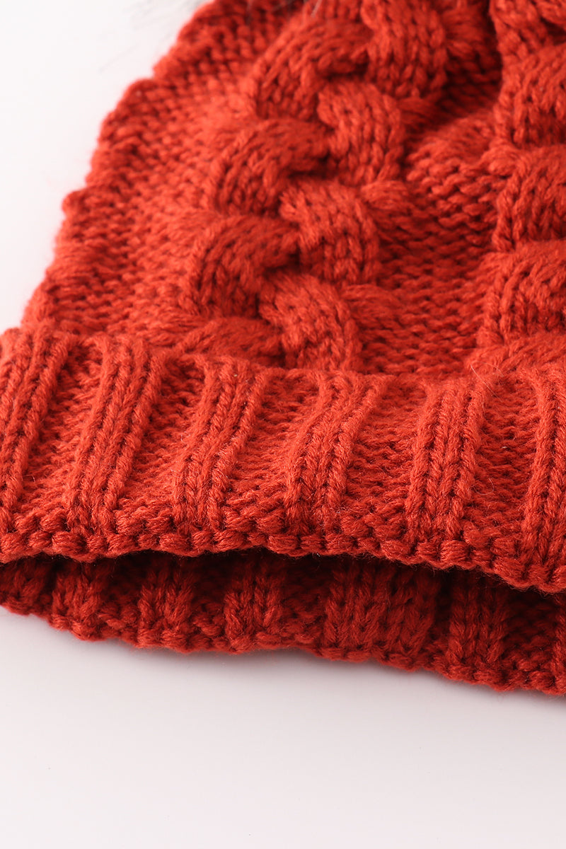 Bonnet en tricot torsadé couleur caramel à pompon