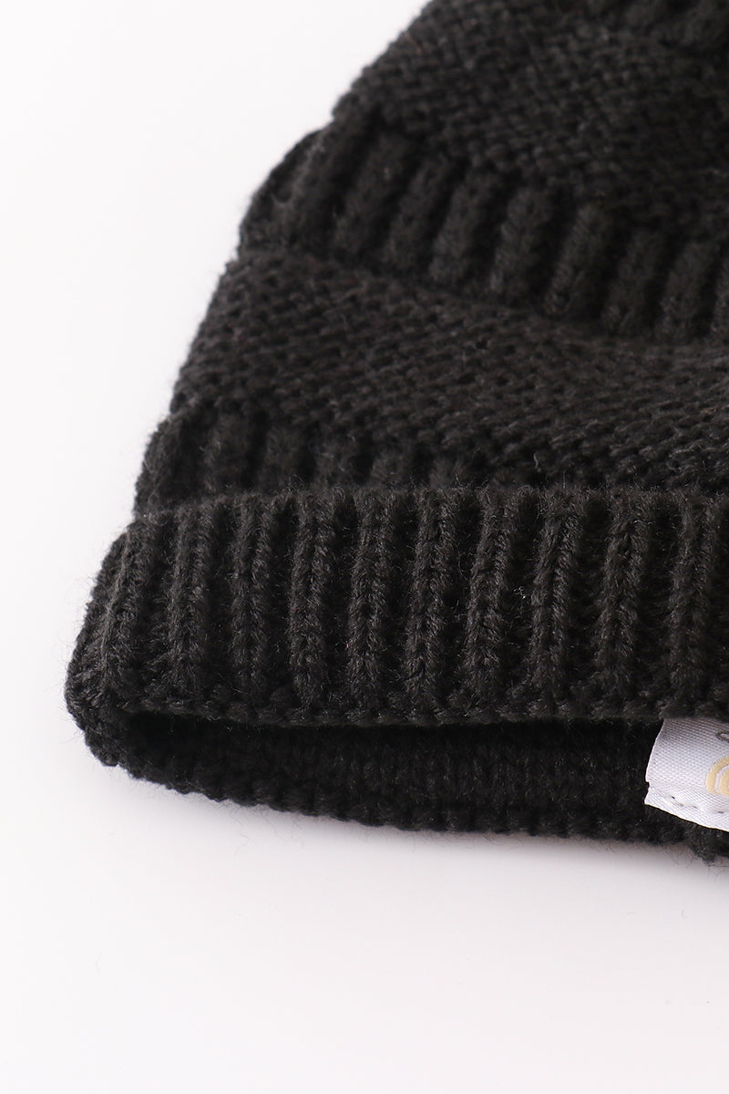 Bonnet à pompon en tricot torsadé noir