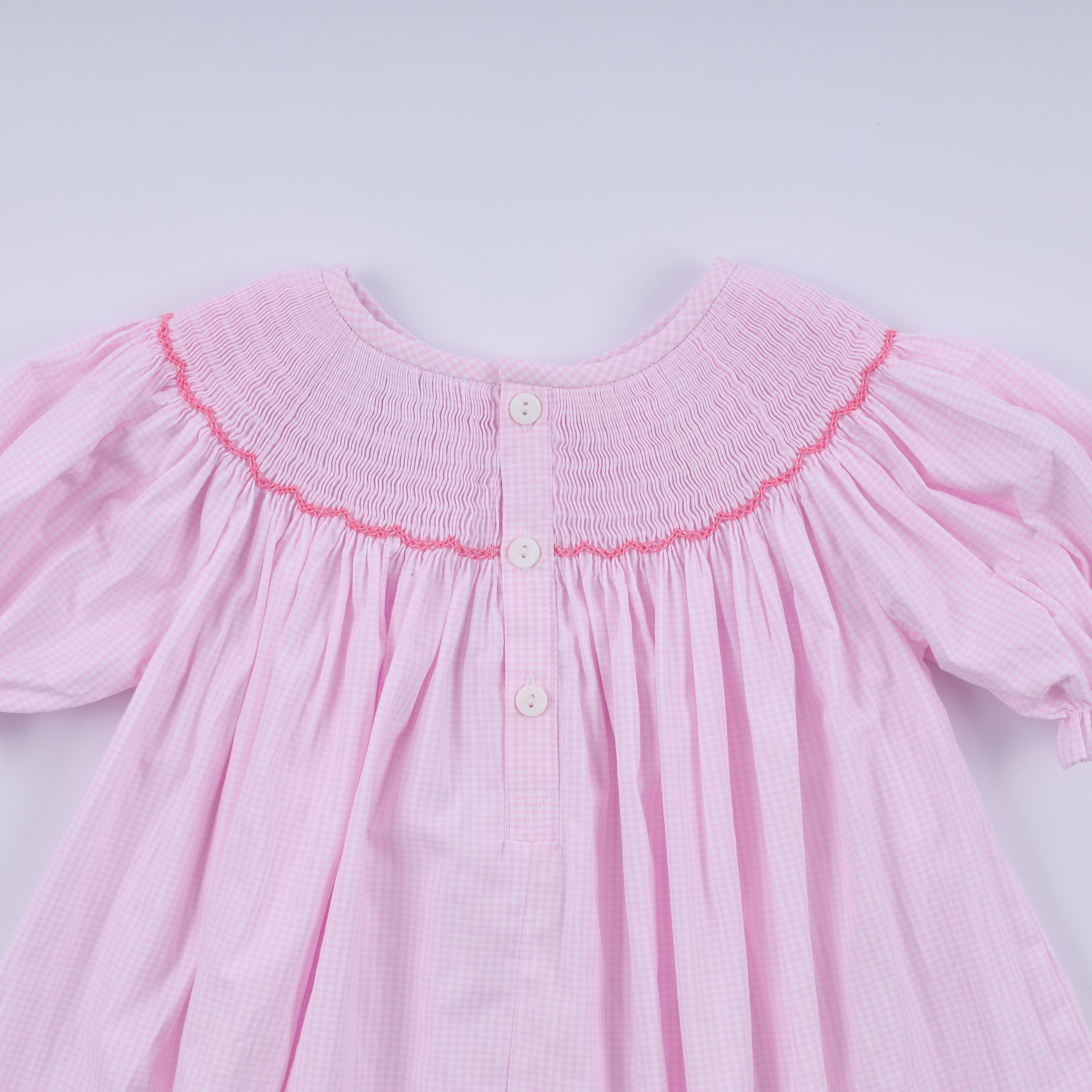 Robe rose à smocks faite main pour Noël