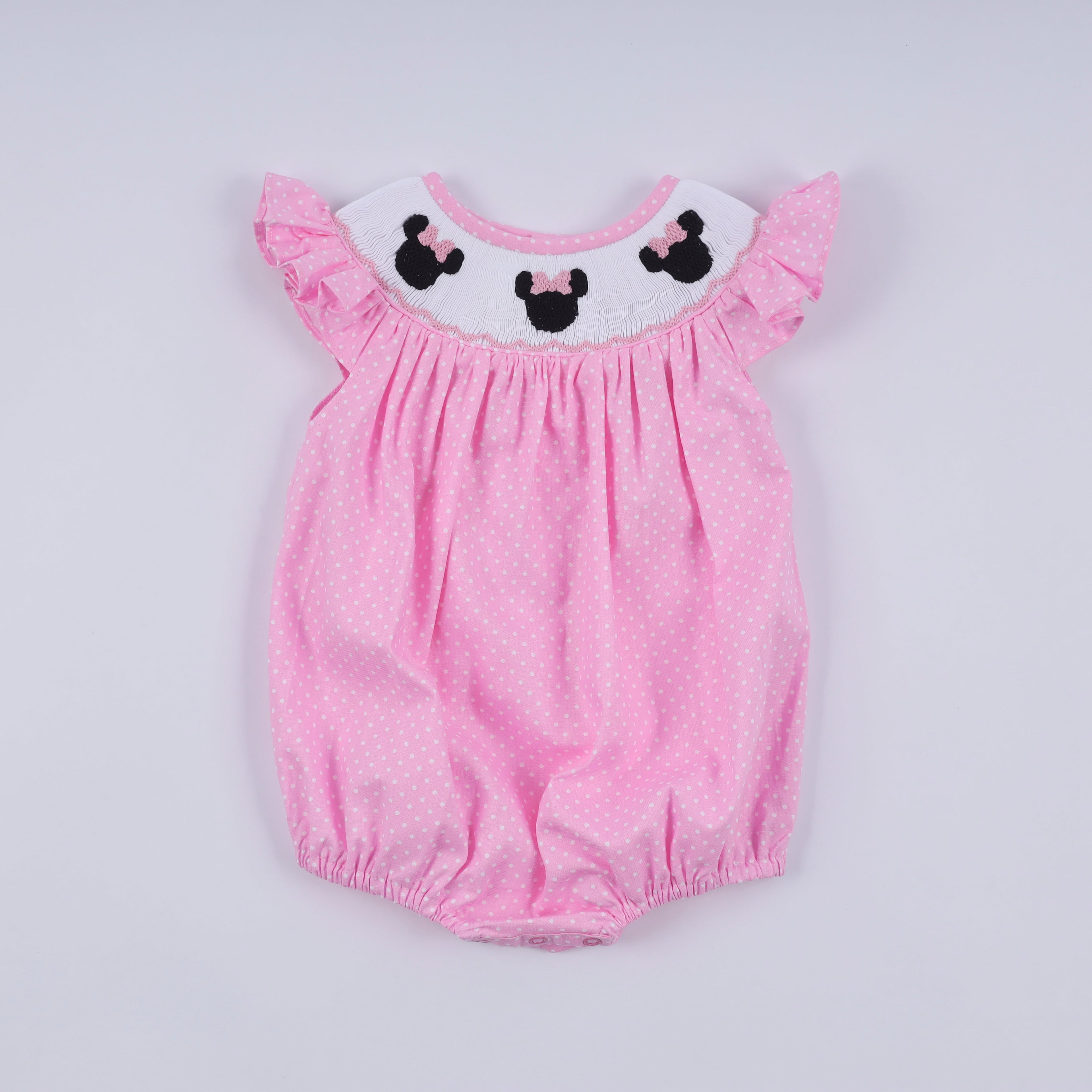 Barboteuse rose à smocks main, pois et volants