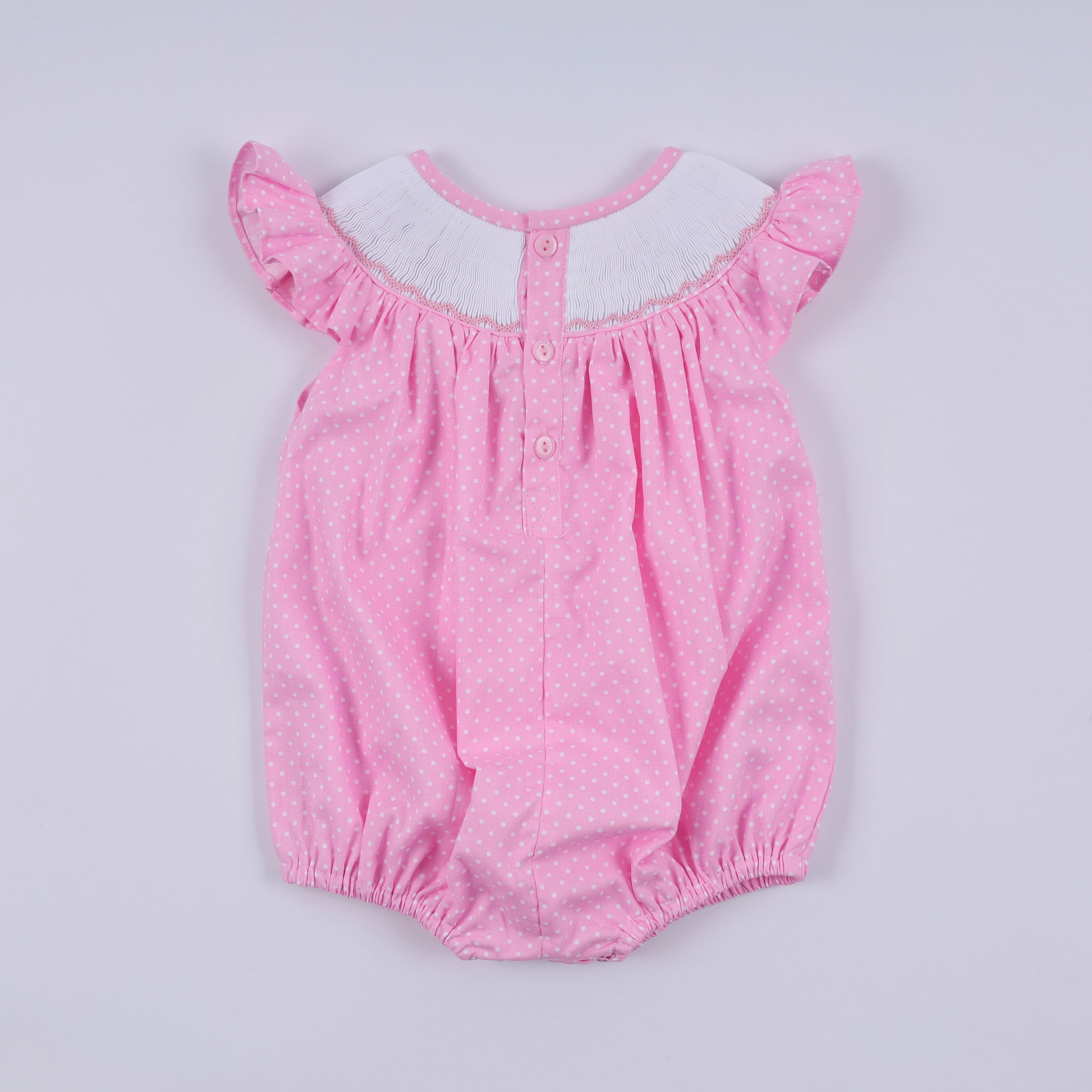 Barboteuse rose à smocks main, pois et volants