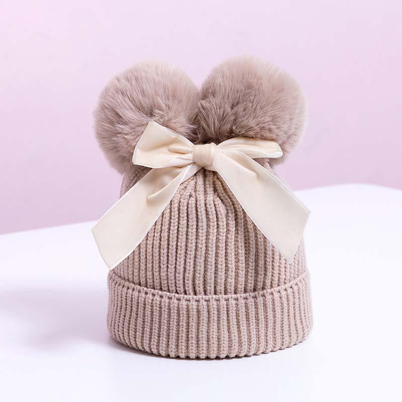 Bonnet tricoté bébé à double pompon pour petite fille, chaud et épais, pour enfant en bas âge, au design hivernal moderne et élégant avec un grand nœud.