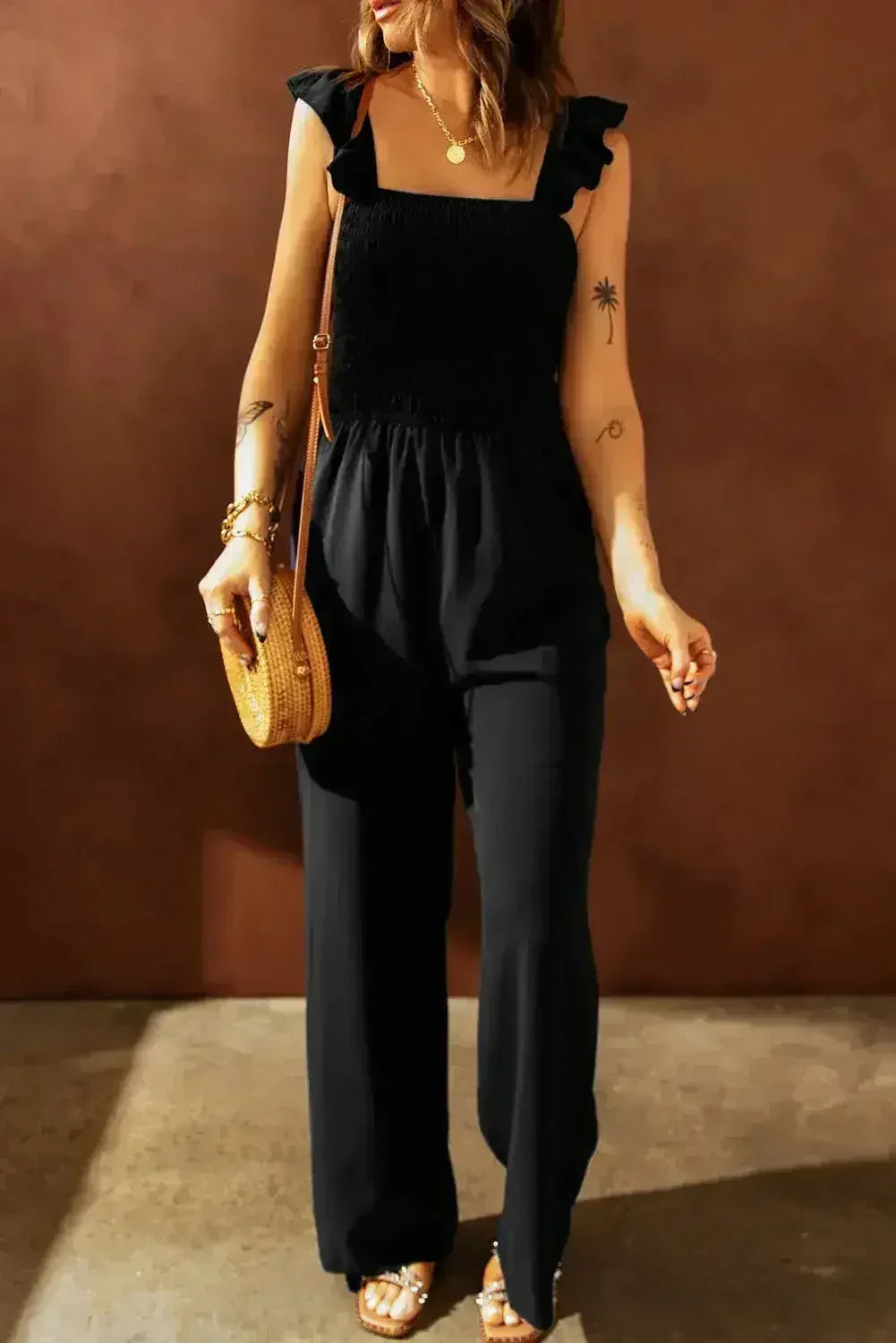 Combinaison-pantalon noire chic à jambes larges