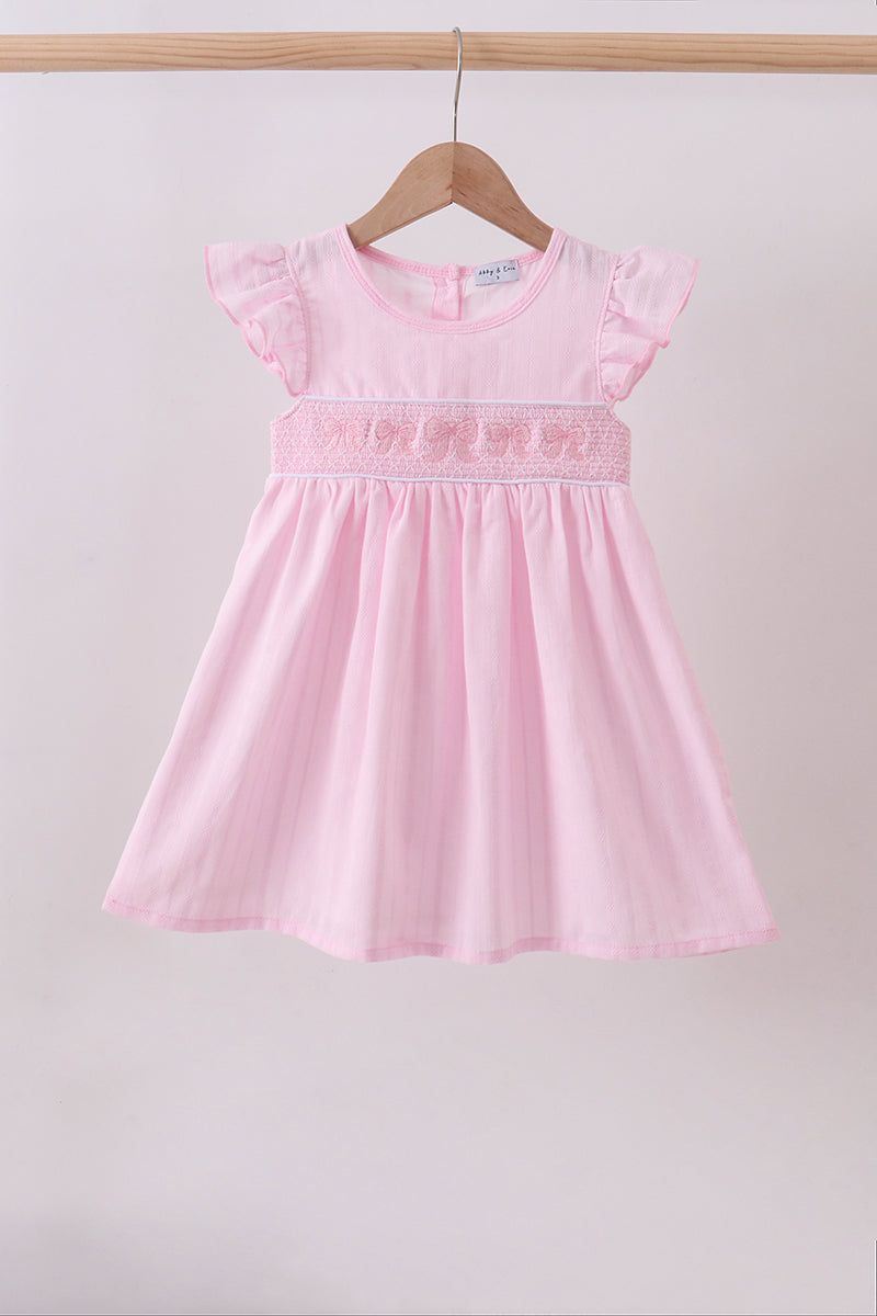 Robe smockée à volants et nœud rose