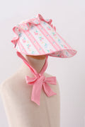 Bonnet à volants et nœud, imprimé floral rose poudré