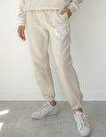 Notre monde a besoin de Jésus - Pantalon de jogging unisexe beige