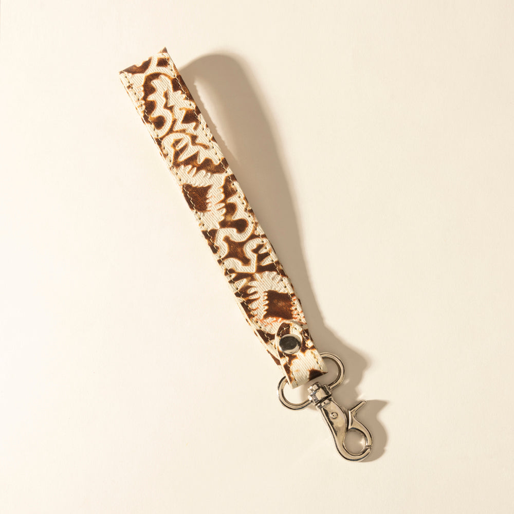 Porte-clés Myra Sierra en cuir marbré avec pompon crème