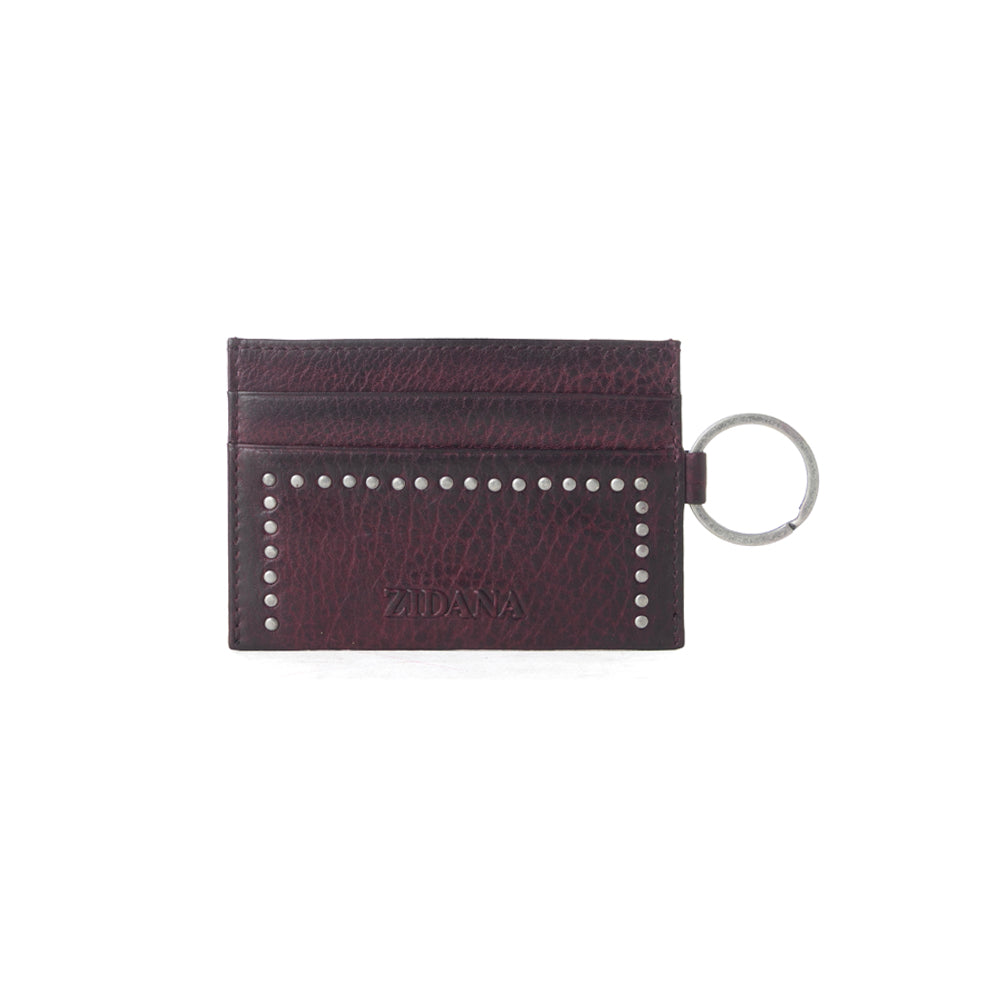 Portefeuille Myra Zidana Steelhoof en cuir tanné végétal clouté, couleur prune sienne