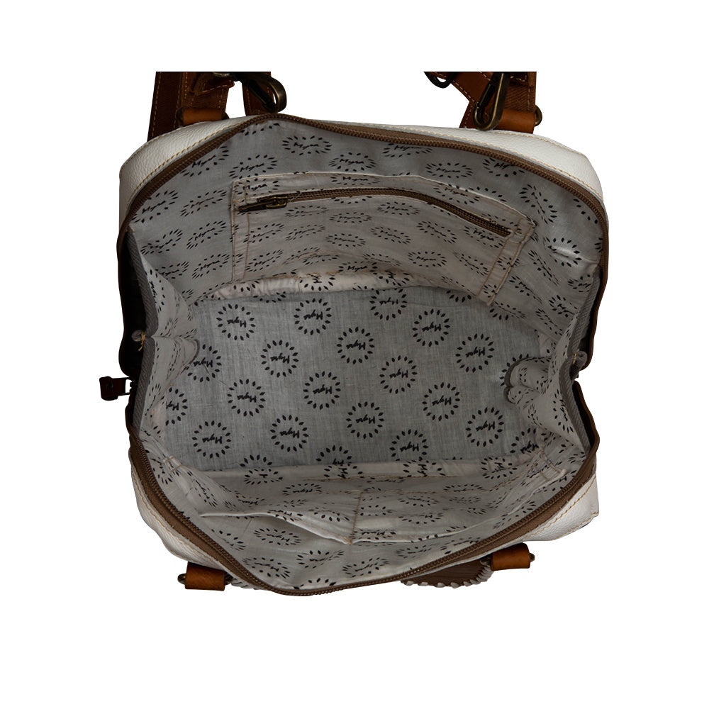 Sac à dos en toile et cuir de vachette à motif herbes des prairies.
