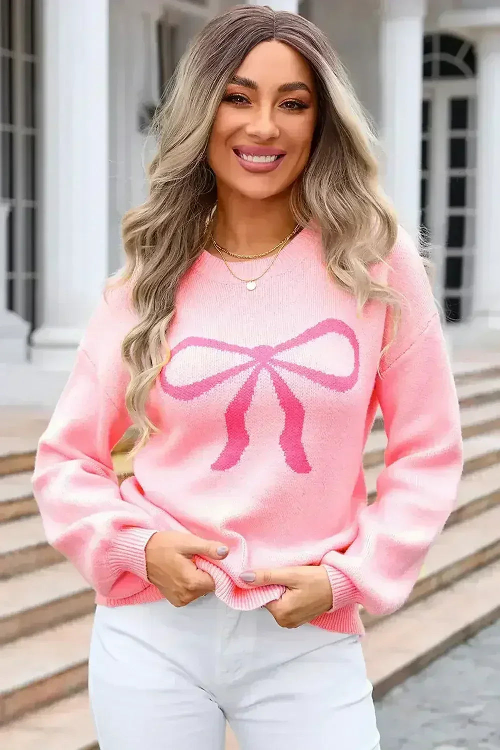 Pull col rond à nœud rose