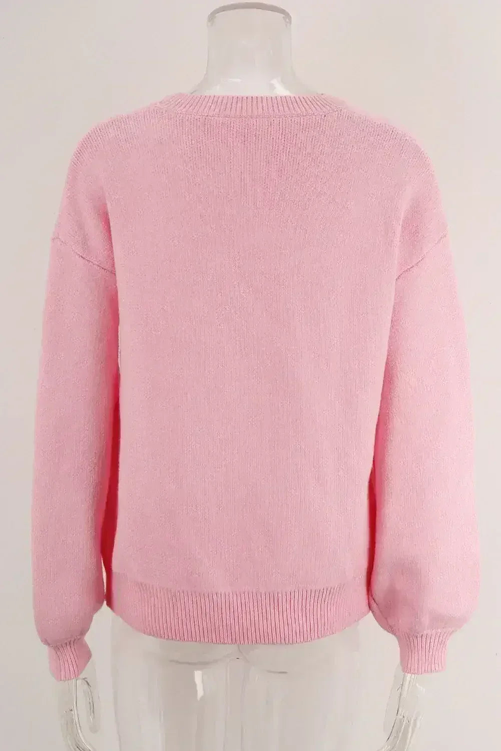 Pull col rond à nœud rose
