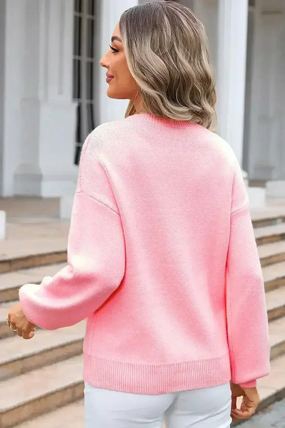 Pull col rond à nœud rose