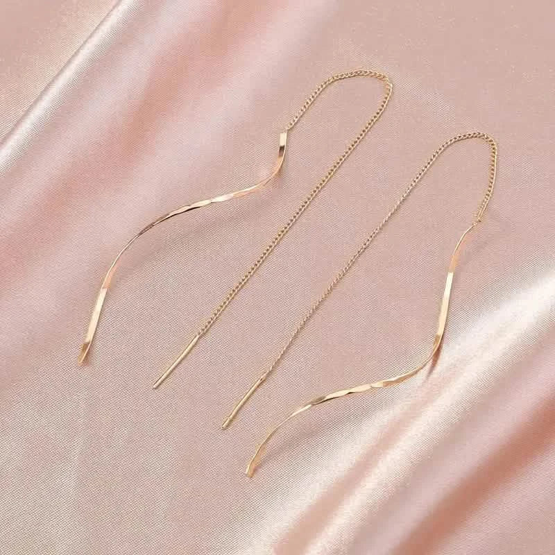Boucles d'oreilles pendantes dorées motif S