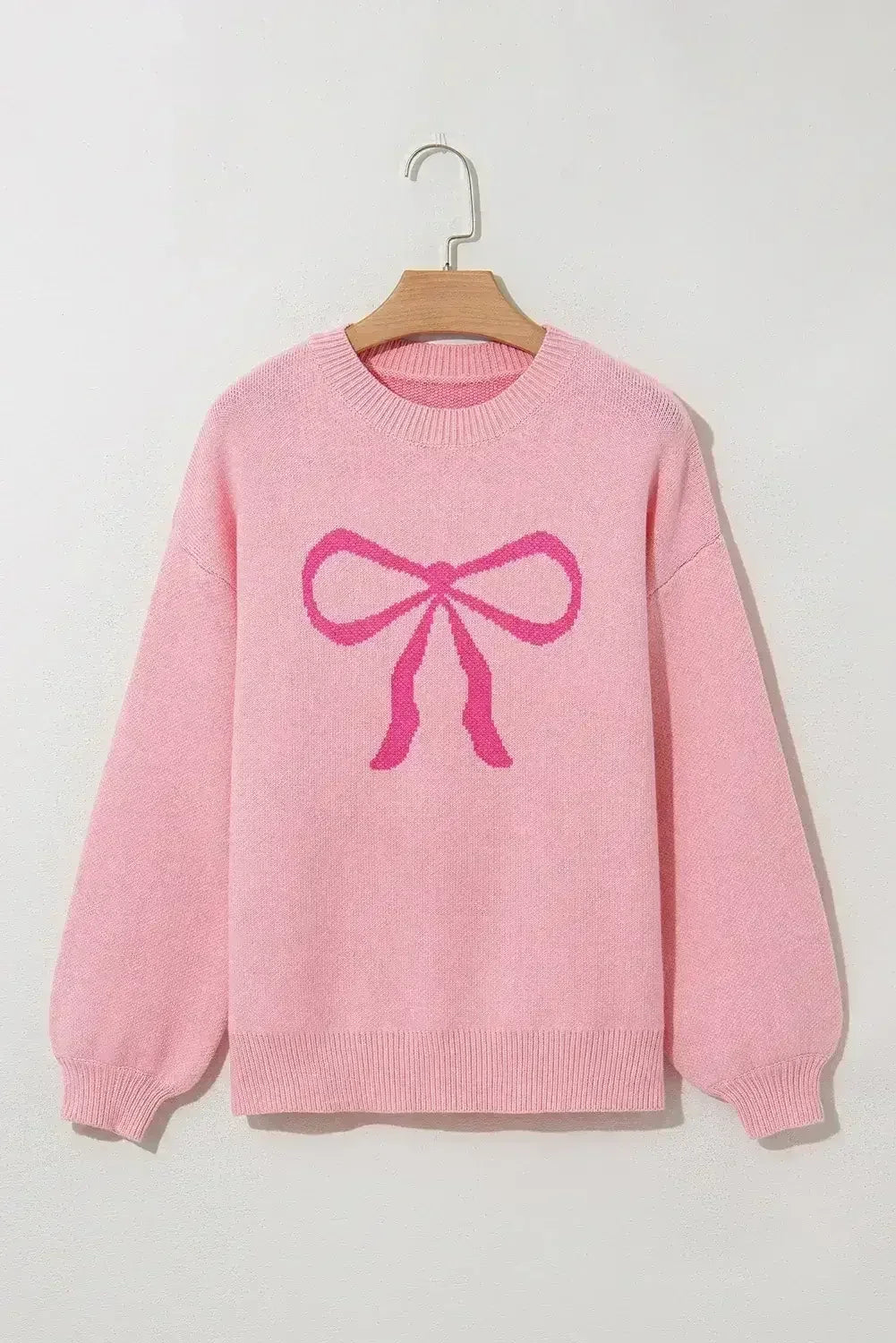 Pull col rond à nœud rose