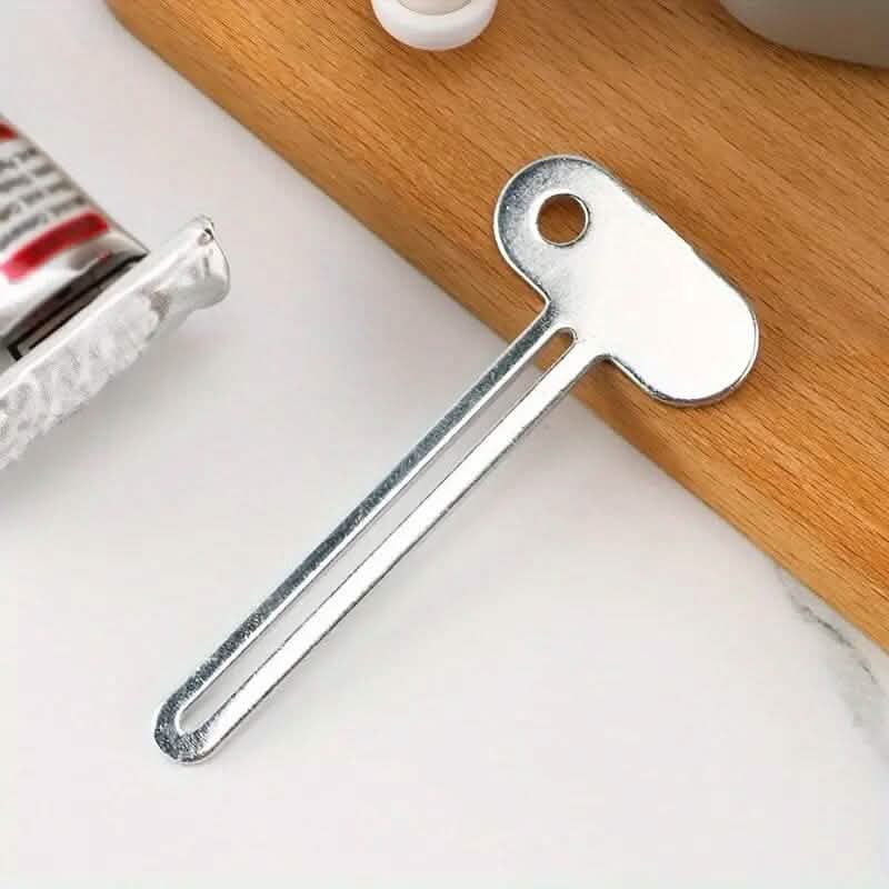 Outil distributeur de tube à presser manuel pour dentifrice