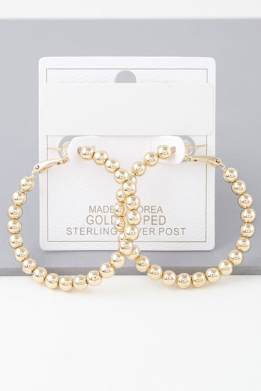 Boucles d'oreilles créoles perlées brillantes