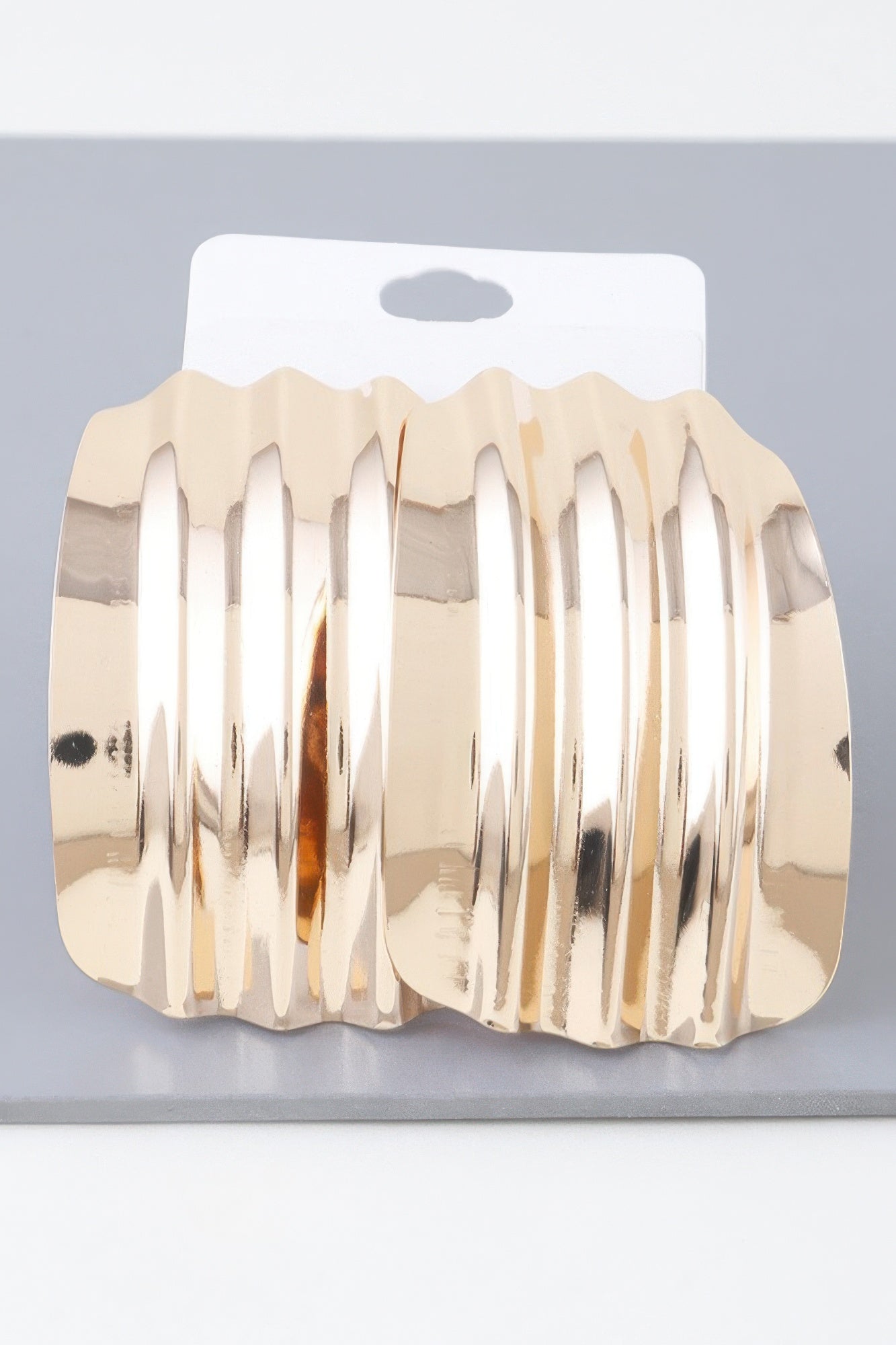 Boucles d'oreilles courbées nervurées brillantes