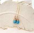 Boucles d'oreilles pendantes en turquoise or 14 carats