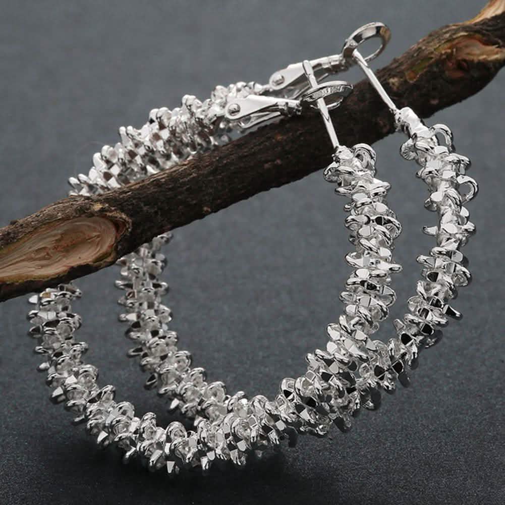Boucles d'oreilles créoles pendantes Roc en or blanc